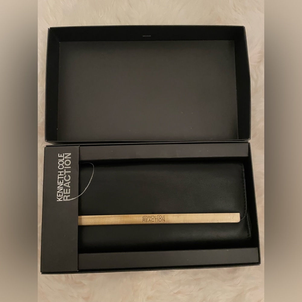 Black, Kenneth Cole clutch. Brand new still in the box.